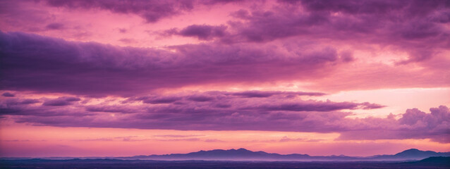 Panoramic view of a pink and purple sky at sunset. Sky panorama background.