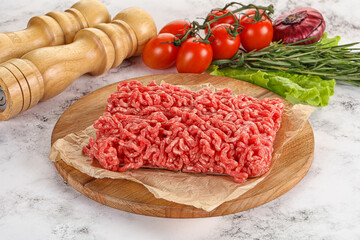 Raw minced beef meat on cutting board