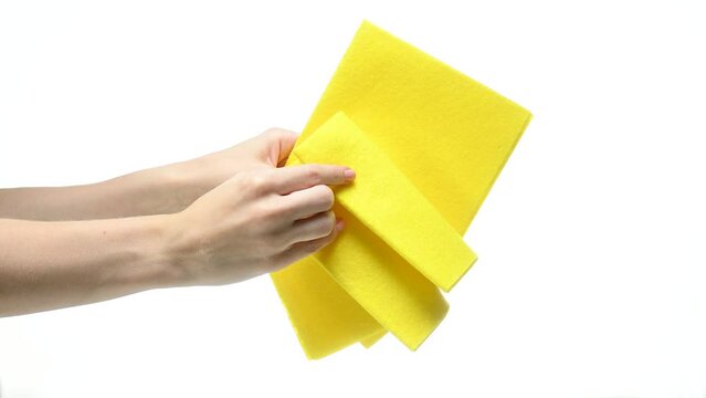 Yellow rags cleaning washing in hand on white background isolation