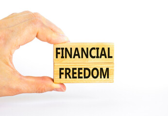 Financial freedom symbol. Concept words Financial freedom on beautiful wooden blocks. Beautiful white table white background. Businessman hand. Business financial freedom concept. Copy space.