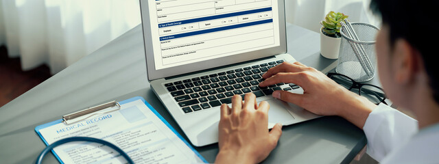 Doctor carefully review detailed medical report on laptop and diagnosing illness for effective...