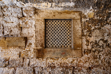 closeup of old window with bars, street view of the old town Dubrovnik, Croatia, medieval European architecture