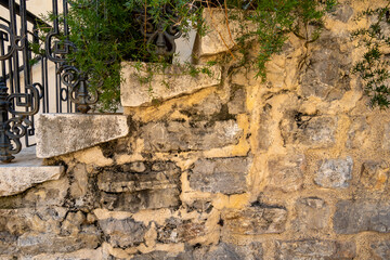 background of an old brick wall with ivy under the steps to the entrance to the house
