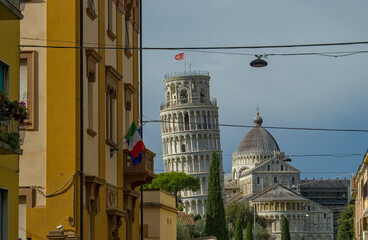 View on the leaning tower of Pisa and Cathedral from a street