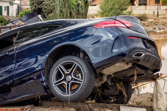 El Alamo, Madrid, Spain; 09-04-2023: Mercedes brand car destroyed on the banks of a river after a strong summer storm after being swept away by the force of the water