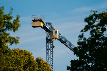 Construction crane cabin on blue sky background