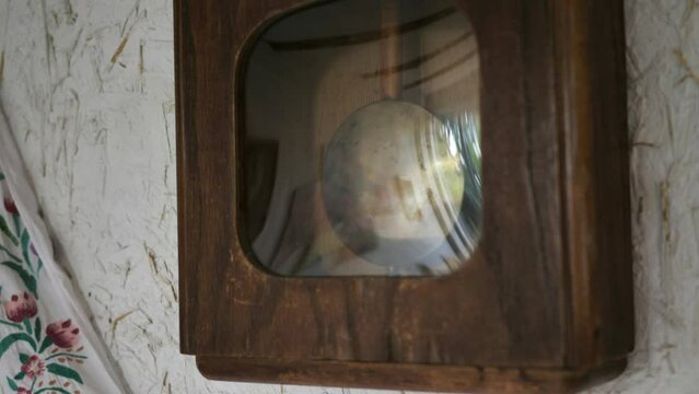 The pendulum of the clock moves to the rhythm of the music, evoking a feeling of nostalgia.Vintage clock on the wall