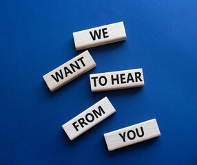 We want to hear from you symbol. Wooden blocks with words We want to hear from you. Beautiful deep blue background. Business and We want to hear from you. Copy space.