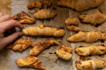home made pastry in hand and on a baking tray