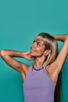 Confident smiling woman with hairy armpit