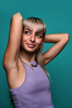 Confident smiling woman with hairy armpit