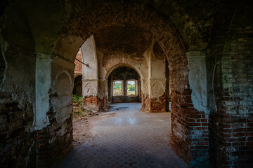 Fototapeta na wymiar Large ancient vaulted corridor of abandoned church, castle etc.