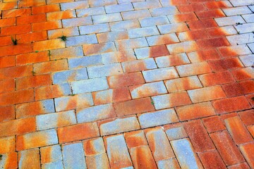 Very dirty sidewalk covered with rust