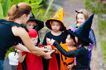 Kids trick or treat. Halloween. Child at door.