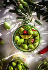 fresh green olives with leaves and olive oil