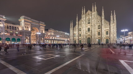 Fototapeta na wymiar Panorama showing Milan Cathedral and Vittorio Emanuele gallery night timelapse.