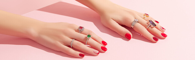 Womans hand with rinds on pink background