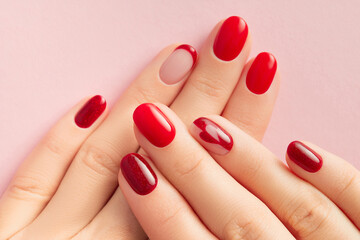 Womans hands with trendy red shiny manicure. Beauty treatment spa body care concept