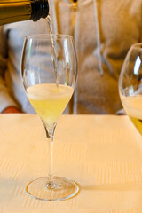 Tasting of grand cru sparkling white wine with bubbles champagne in old champagne house in grand cru wine producer small village Ambonnay, Champagne, France
