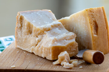 Traditional italian food - 36 months aged in caves Italian parmesan hard cheese from Parmigiano-Reggiano, Italy