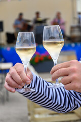 Tasting of sparkling white wine with bubbles champagne on summer festival route of champagne in Cote des Bar, Champagne region, France