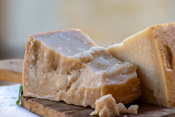 Traditional italian food - 36 months aged in caves Italian parmesan hard cheese from Parmigiano-Reggiano, Italy