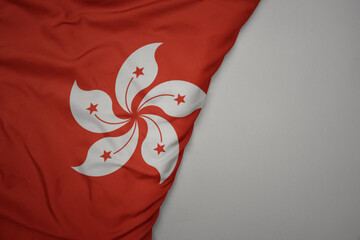 big waving national colorful flag of hong kong on the gray background.