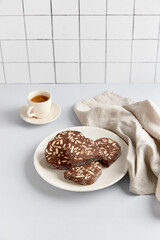 Traditional portuguese dessert Salame de Chocolate on beige background in minimal style. Homemade cocoa cake.