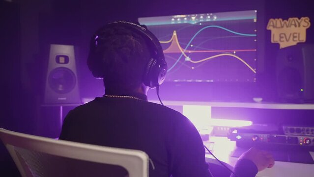 black man is working in modern music recording studio, sound engineer with digital audio workstation