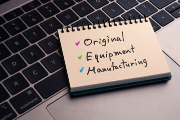 There is notebook with the word Original Equipment Manufacturing. It is as an eye-catching image.