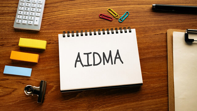There is notebook with the word AIDMA. It is as an eye-catching image.