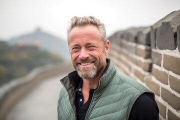 Close-up portrait photography of a pleased man in his 40s that is with the family at the Great Wall of China in Beijing China