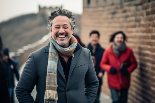 Lifestyle Portrait Photography Of A Grinning Man In His 40s That Is Smiling With Friends At The Great Wall Of China In Beijing China