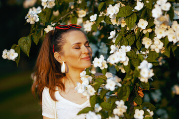 happy modern 40 years old woman in white shirt