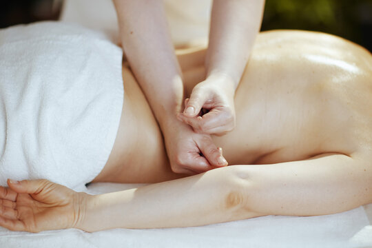 Closeup on medical massage therapist do therapeutic massage