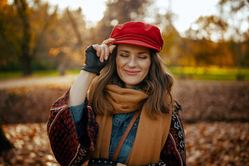 smiling modern 40 years old woman in red hat with scarf