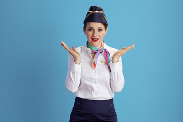 Fototapeta premium surprised modern female air hostess on blue