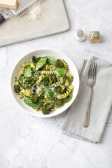 Bowl of Broccoli Pesto Pasta on a White Background