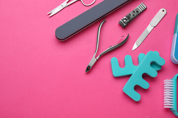 Set of pedicure tools on pink background, flat lay. Space for text