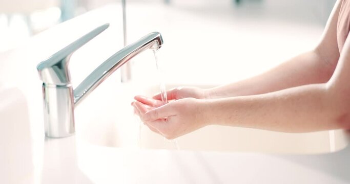 Water, soap and a person washing hands in the bathroom for health, hygiene or sustainability. Cleaning, skincare and remove bacteria with an adult in a home for wellness or natural disinfection