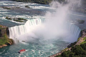 Aerial view of Horseshoe Falls including Hornblower Boat sailing on Niagara River, Canada and USA natural border