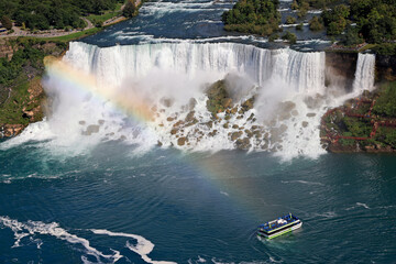 Aerial view of American and Bridal Veil Falls including maid of the Mist boat sailing on Niagara River, Canada and USA natural border