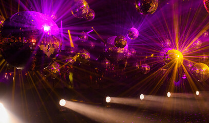 disco music background with mirror balls and colorful rays