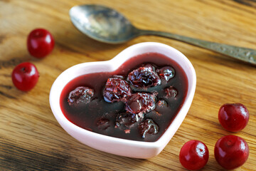 bowl of cherry jam with fresh fruits on a wooden table, top view close up - Powered by Adobe