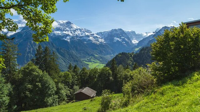 Time lapse of clouds passing mountains. View down the mountain valley. Linthal, Canton of Glarus, Switzerland
