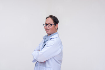 A friendly doctor of asian descent, middle aged male in his 40s with arms crossed. Side view,...