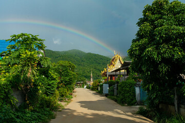 A rainbow appears in the village before it rains.