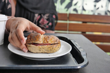 women hand holding beef burger 