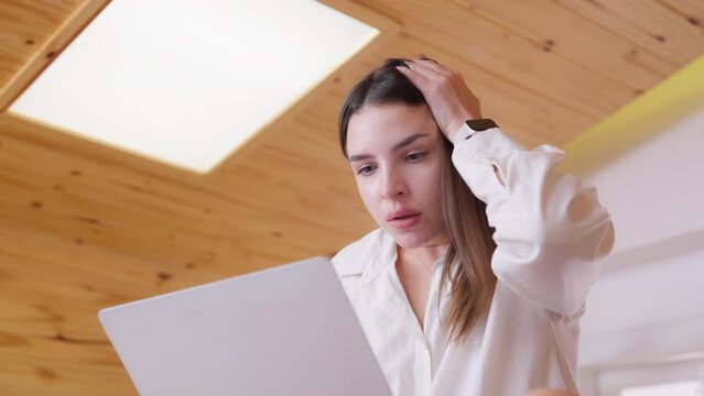 Tired, exhausted woman working on computer laptop, problems with job, feeling depressed, laziness in living room
