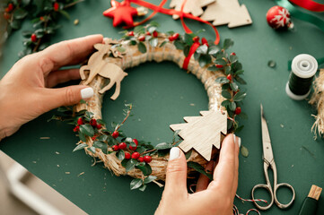 Woman holding Christmas wreath in hands